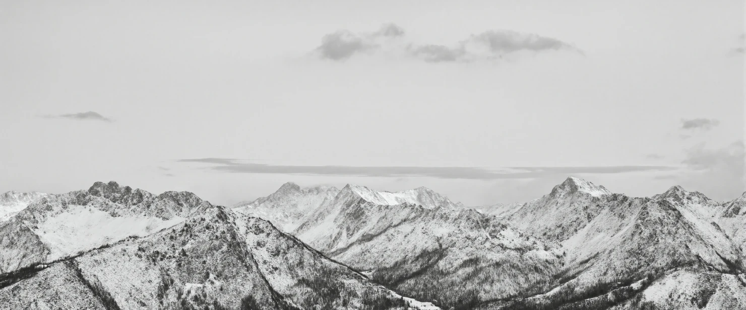 Monochrome Majesty Snow-Capped Mountain Range Under Cloudy Skies #40973