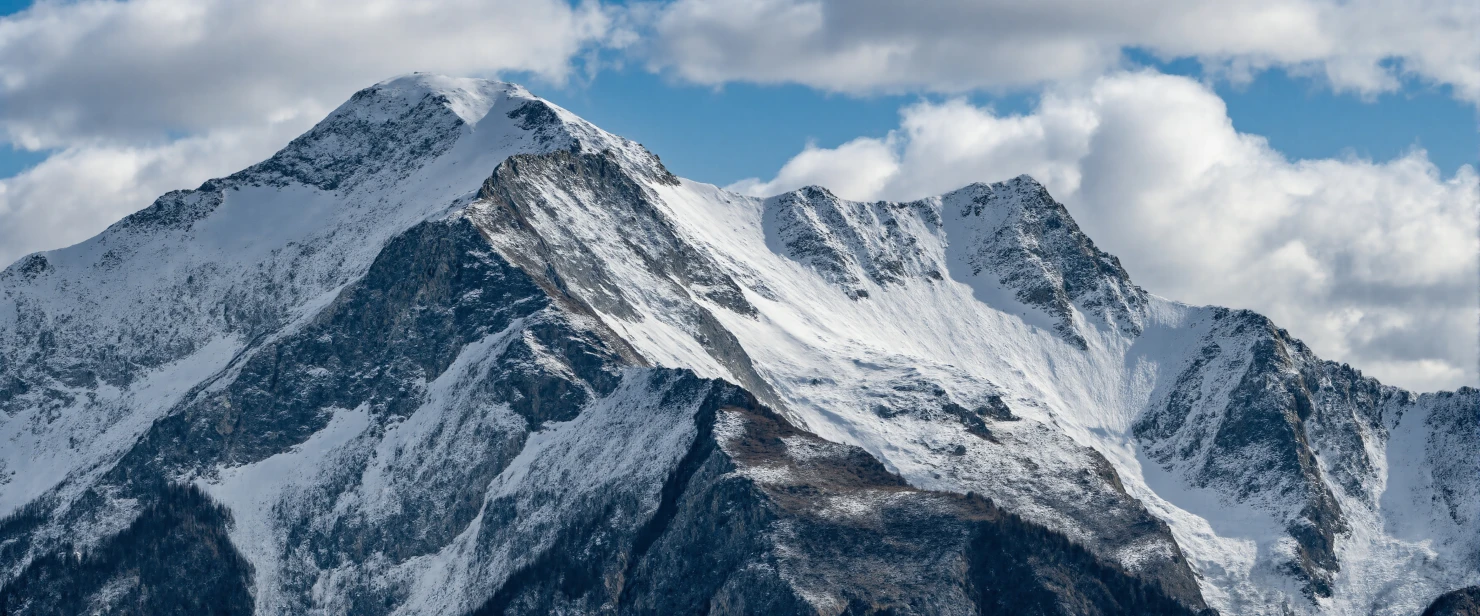 Majestic Snow-Capped Mountain Peaks Under a Cloudy Sky #41060