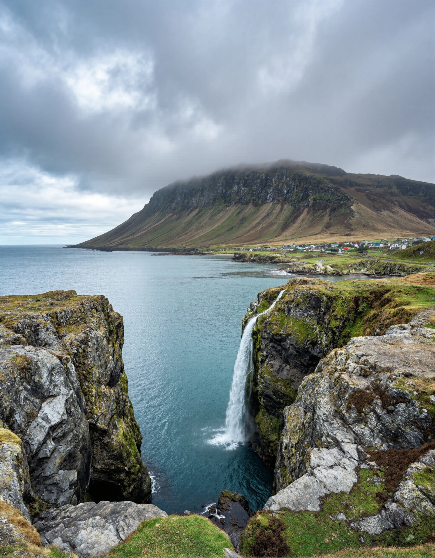 Coastal Waterfall Plunging into the Ocean with Mountain Backdrop #41070