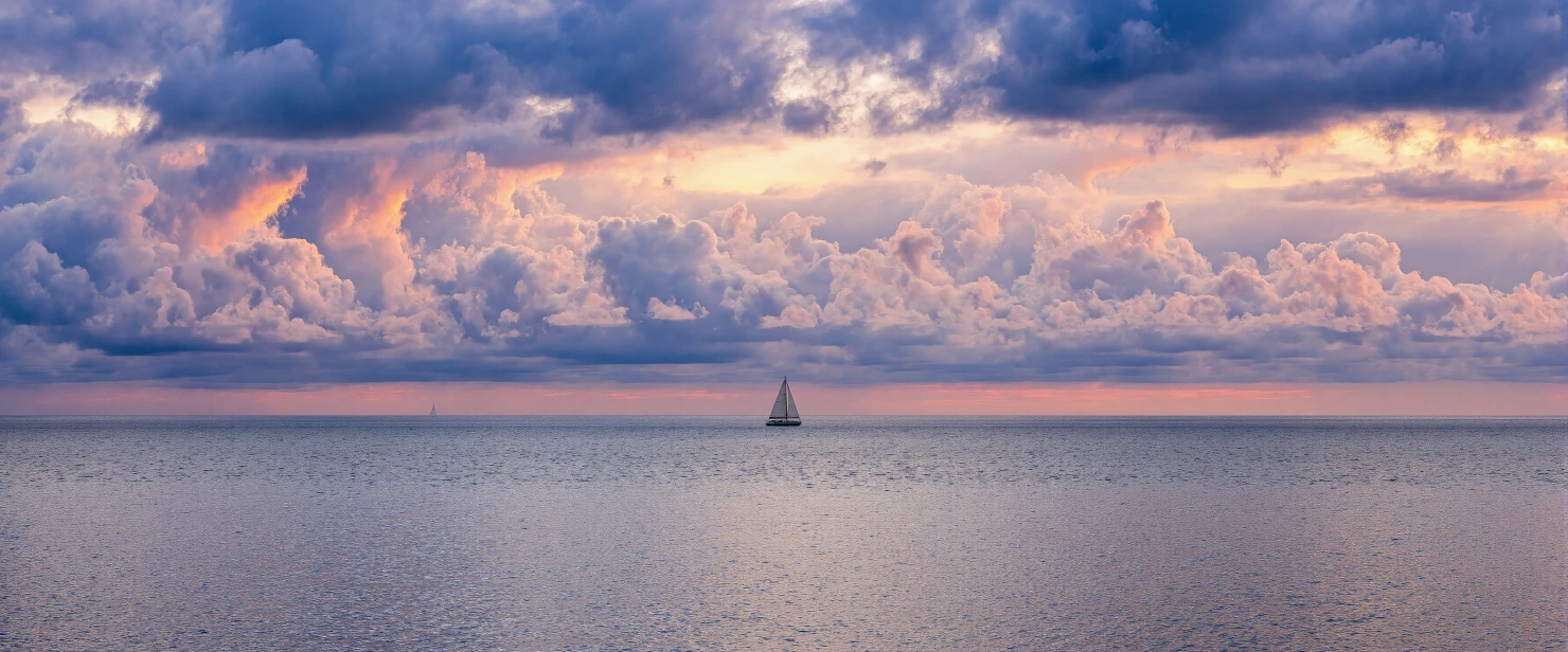Peaceful Ocean Horizon with a Sailboat Under a Dramatic Sky #41110