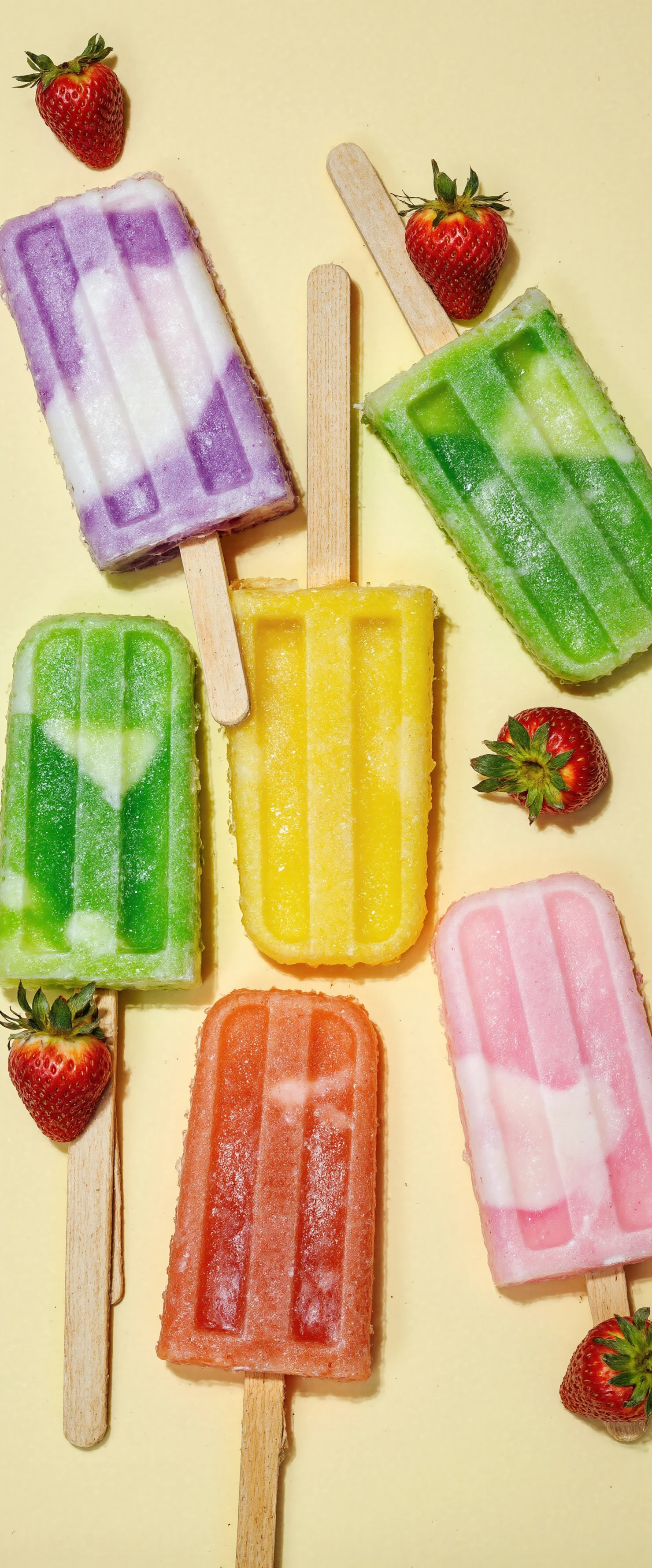 Vibrant Fruit Popsicles and Fresh Strawberries on Yellow Background #41142