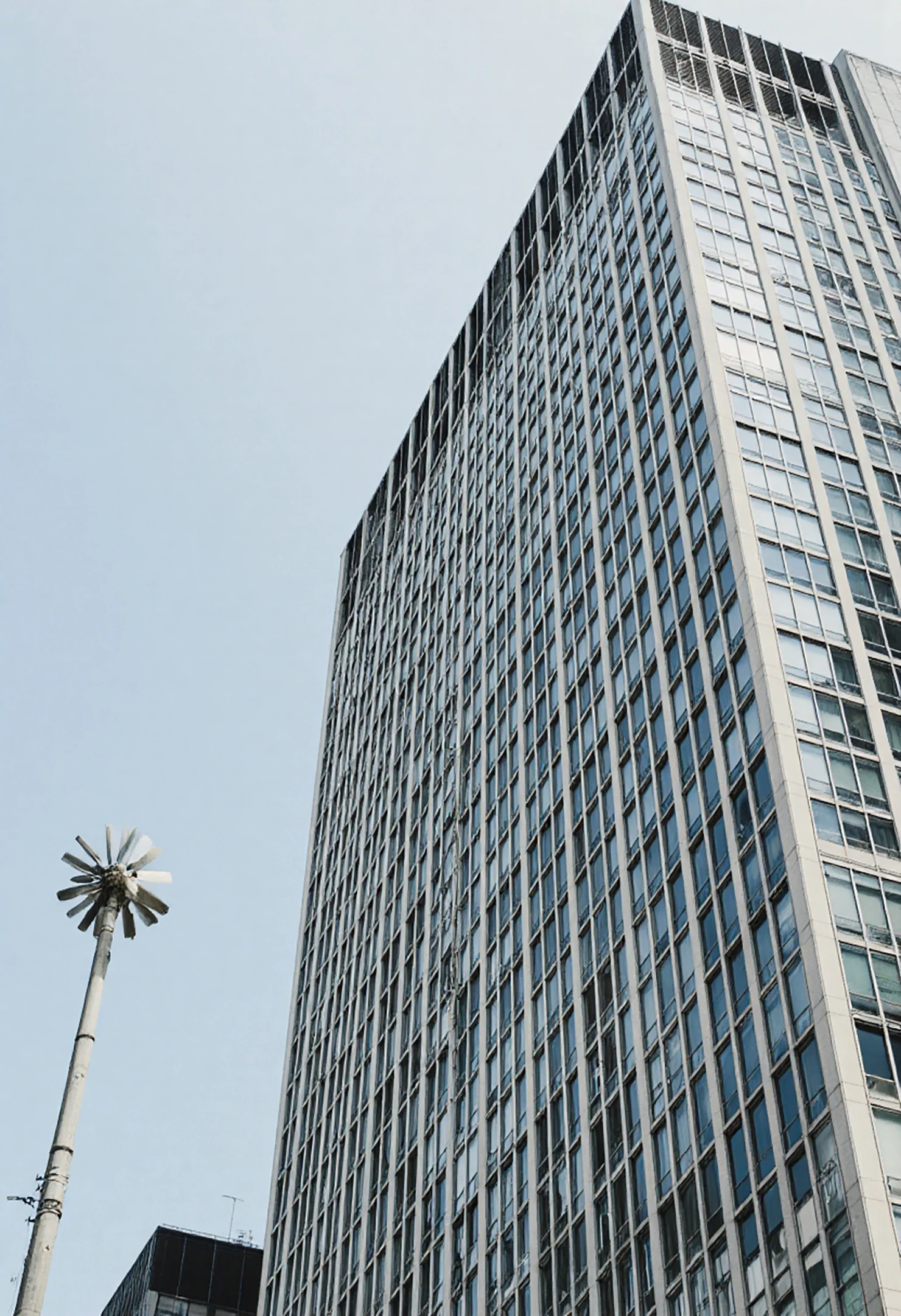 Modern Skyscraper and Urban Pole Against a Clear Sky #41194