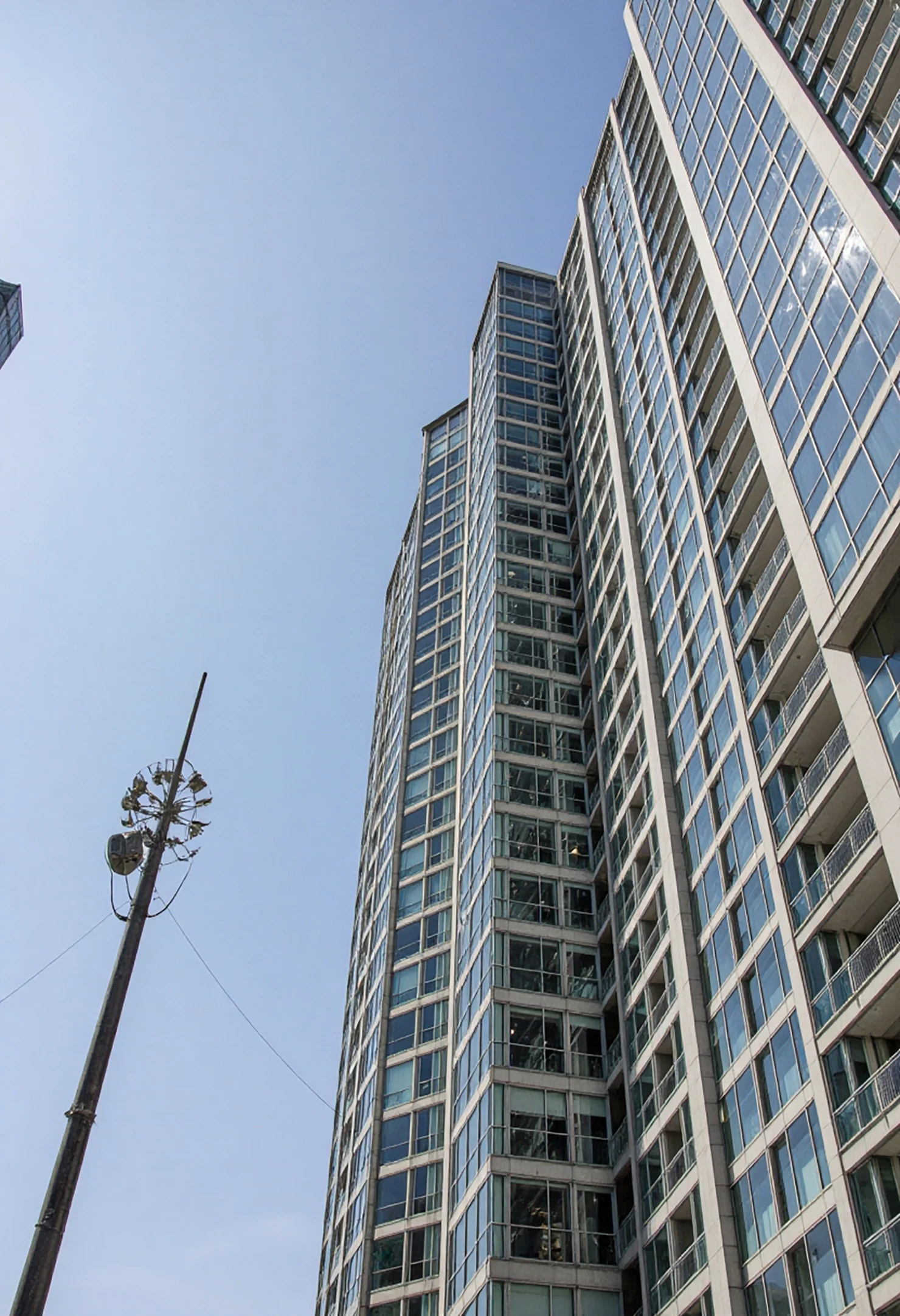 Modern Skyscraper and Urban Pole Against a Clear Sky #41195