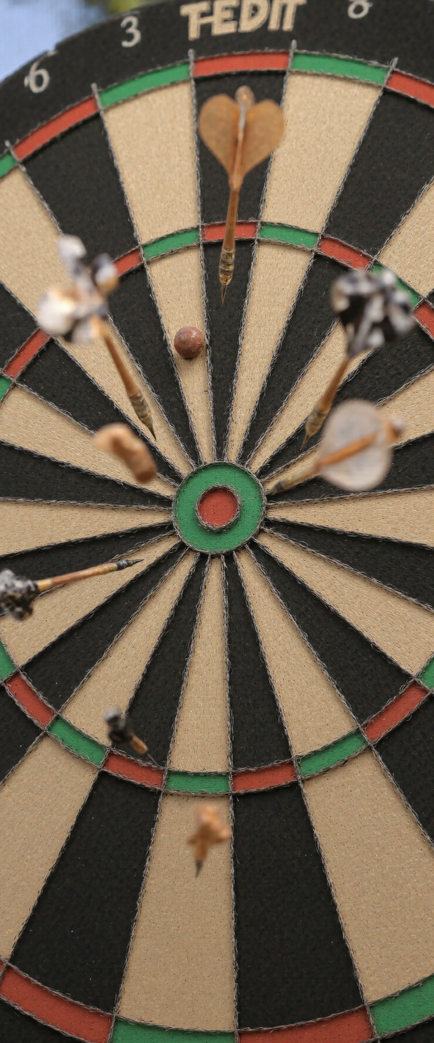 Darts Game in Progress on a Dartboard #41202