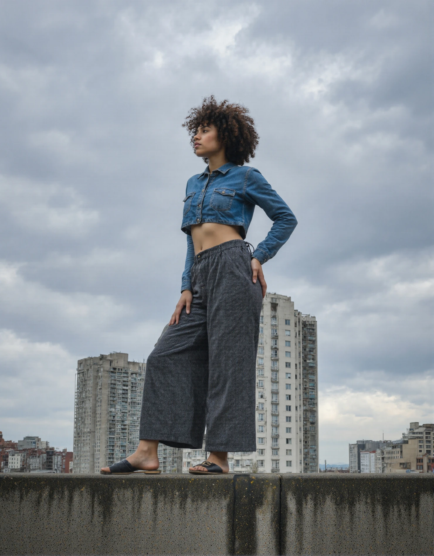 Confident Woman in Urban Landscape Against a Cloudy Sky #41217